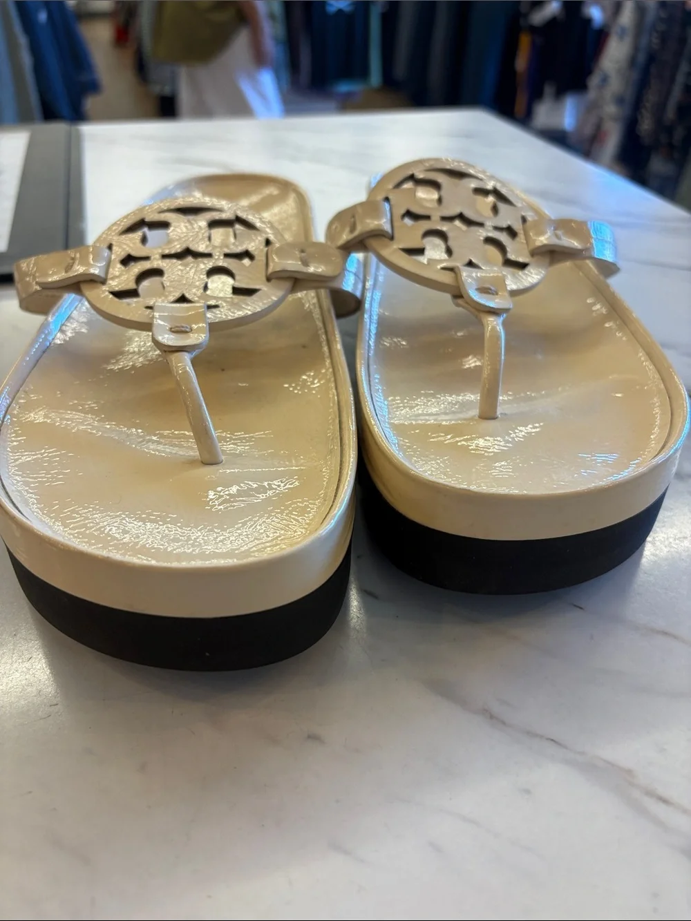 Tory Burch Patent Logo Thong Sandals in Light Beige with a chunky heel.